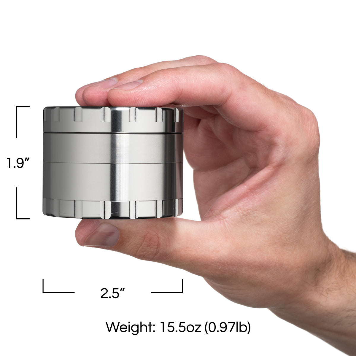 The Reaper Stainless Steel Grinder in a hand with illustrated measurements. 1.9" height and 2.5" diameter. Weight is 15.5oz or 0.97lb.
